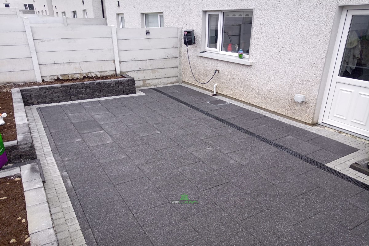 Patio with Charcoal And Silver Granite Slabs and Connemara Walling in